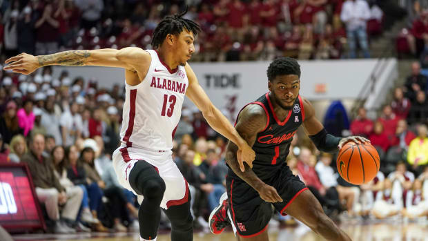 Houston Cougars guard Jamal Shead (1) drives to the basket against Alabama Crimson Tide guard Jahvon Quinerly (13) during the first half at Coleman Coliseum.
