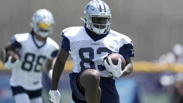 Cowboys wide receiver works out with a football during a training camp practice.