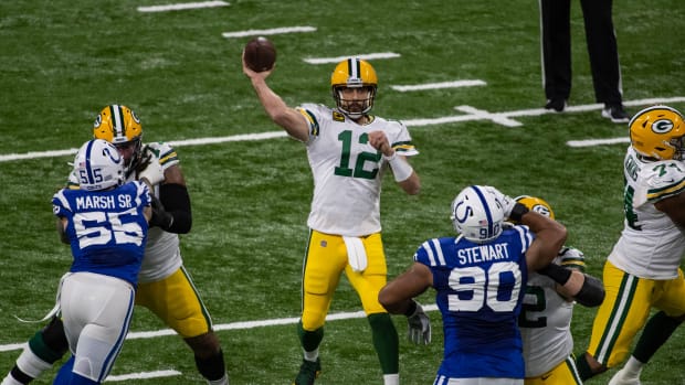 Nov 22, 2020; Indianapolis, Indiana, USA; Green Bay Packers quarterback Aaron Rodgers (12) passes the ball in the first half against the Indianapolis Colts at Lucas Oil Stadium.