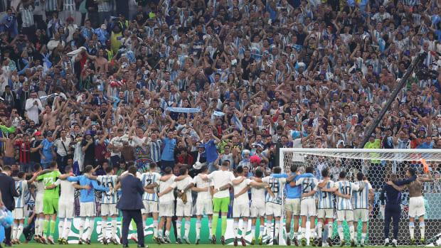 Argentina players sing with their fans at the World Cup