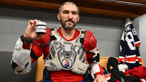 Alex Ovechkin poses with the pucks from his 798th, 799th and 800th career goals