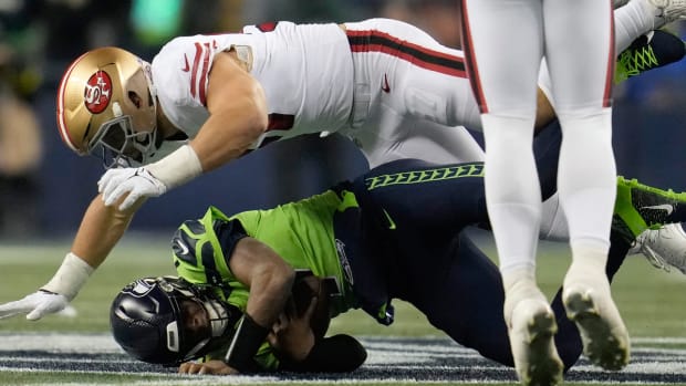49ers defensive end Nick Bosa sacks Seahawks quarterback Geno Smith during a game.