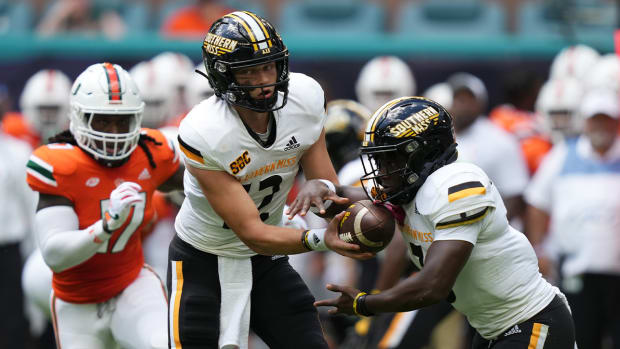 Sep 10, 2022; Miami Gardens, Florida, USA; Southern Miss Golden Eagles quarterback Zach Wilcke (12) hands the ball to Southern running back Frank Gore Jr. (3) during the first half against the Miami Hurricanes at Hard Rock Stadium.
