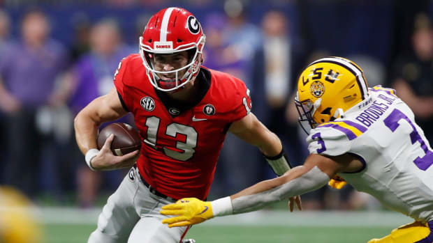 Georgia quarterback Stetson Bennett (13) moves the rock during the first half of the SEC Championship NCAA college football game between LSU and Georgia in Atlanta, on Saturday, Dec. 3, 2022.