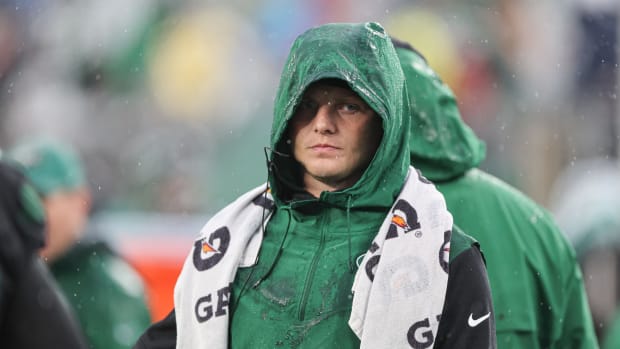 New York Jets QB Zach Wilson standing on sideline during game