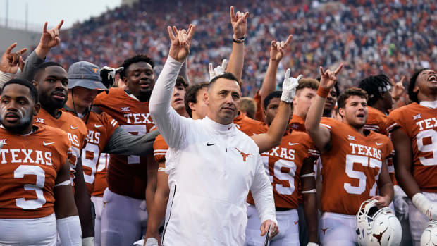 Texas coach Steve Sarkisian gives a horns up gesture