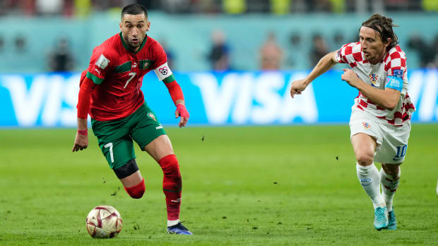 Morocco’s Hakim Ziyech chases after the ball along with Croatia’s Luka Modrić at the World Cup.