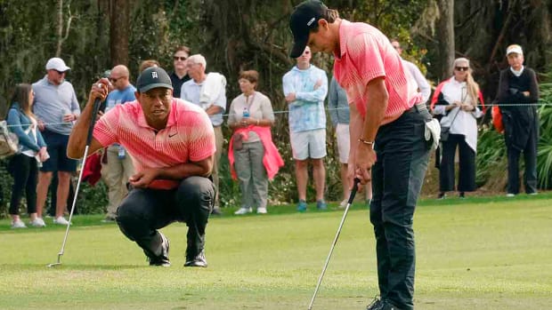 Tiger Woods watches Charlie Woods putt in the first round of the 2022 PNC Championship.