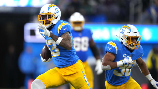 Dec 11, 2022; Inglewood, California, USA; Los Angeles Chargers wide receiver Keenan Allen (13) carries the ball as running back Austin Ekeler (30) blocks during the game against the Miami Dolphins at SoFi Stadium. Mandatory Credit: Kirby Lee-USA TODAY Sports