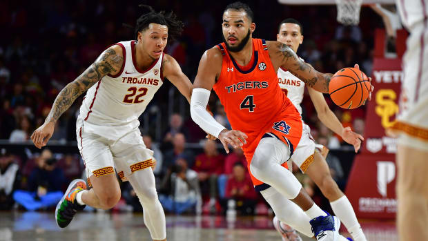 Dec 18, 2022; Los Angeles, California, USA; Auburn Tigers forward Johni Broome (4) moves the ball against Southern California Trojans guard Tre White (22) during the second half at Galen Center. Mandatory Credit: Gary A. Vasquez-USA TODAY Sports