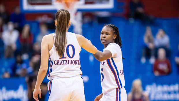Kansas guards Zakiyah Franklin and Ioanna Chatzileonti celebrate after a play against the Tulsa Golden Hurricane in Allen Fieldhouse