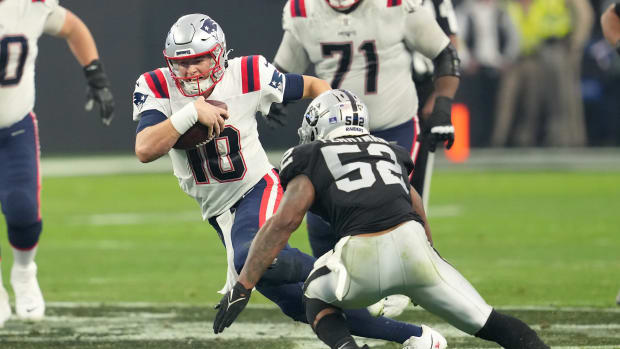 Dec 18, 2022; Paradise, Nevada, USA; New England Patriots quarterback Mac Jones (10) is flushed from the pocket by the Las Vegas Raiders during the second half at Allegiant Stadium.