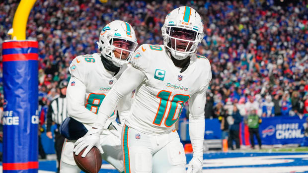 Dec 17, 2022; Orchard Park, New York, USA; Miami Dolphins wide receiver Tyreek Hill (10) reacts to scoring a touchdown against the Buffalo Bills during the second half at Highmark Stadium.