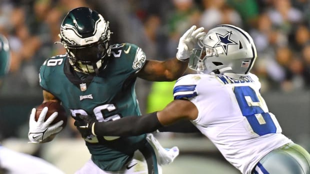 Eagles running back Miles Sanders throws a stiff-arm against the Cowboys.