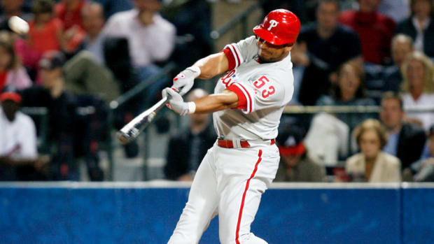 Phillies right fielder Bobby Abreu drives in shortstop Jimmy Rollins against the Braves at Turner Field in Atlanta.