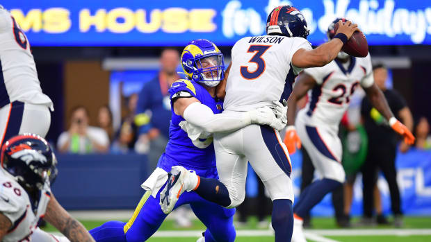 Denver Broncos quarterback Russell Wilson (3) is sacked by Los Angeles Rams defensive tackle Michael Hoecht (97) during the second half at SoFi Stadium.Mandatory Credit: Gary A. Vasquez-USA TODAY Sports