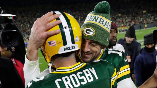 Packers quarterback Aaron Rodgers hugs kicker Mason Crosby after a win in 2018.