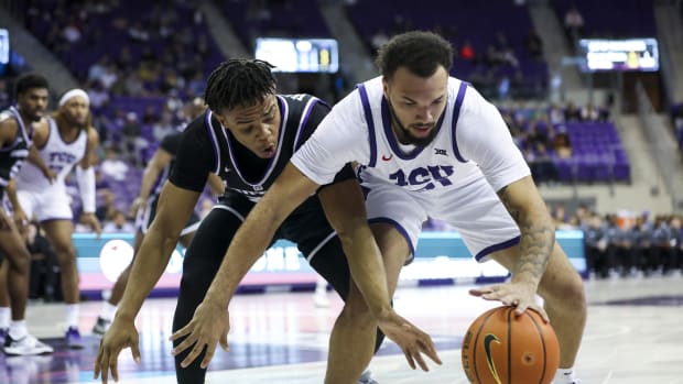 Dec 28, 2022; Fort Worth, Texas, USA; TCU Horned Frogs forward JaKobe Coles (21) and Central Arkansas Bears guard Camren Hunter (23) go for the ball during the first half at Ed and Rae Schollmaier Arena.