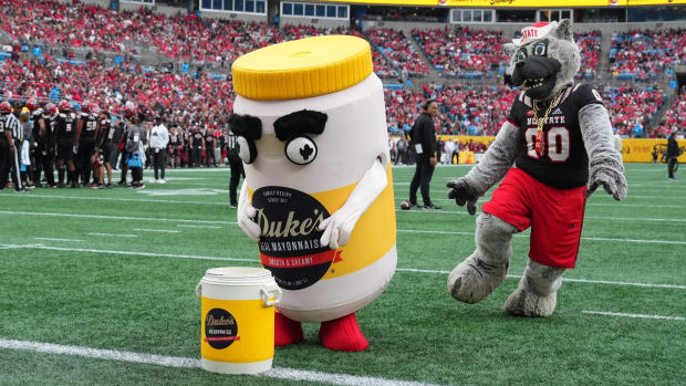 Tubby, the Duke's Mayo Bowl mascot, wins a race over the NC State Wolfpack mascot at halftime.