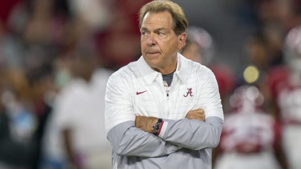 Alabama head coach Nick Saban looks on with crossed arms before a game.