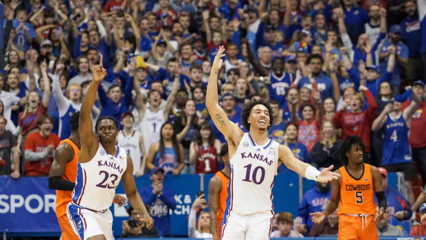Dec 31, 2022; Lawrence, Kansas, USA; Kansas Jayhawks center Ernest Udeh Jr. (23) and forward Jalen Wilson (10) celebrate after the win over the Oklahoma State Cowboys at Allen Fieldhouse. Mandatory Credit: Denny Medley-USA TODAY Sports