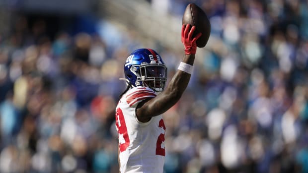 New York Giants safety Xavier McKinney (29) holds up at the ball at the end of the game of a regular season NFL football matchup Sunday, Oct. 23, 2022 at TIAA Bank Field in Jacksonville. The New York Giants defeated the Jacksonville Jaguars 23-17.