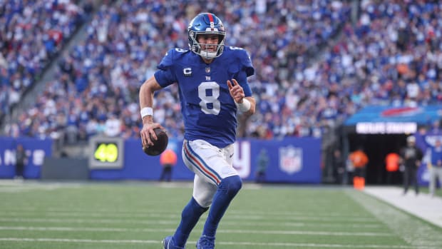 Jan 1, 2023; East Rutherford, New Jersey, USA; New York Giants quarterback Daniel Jones (8) scores a rushing touchdown during the second half against the Indianapolis Colts at MetLife Stadium.