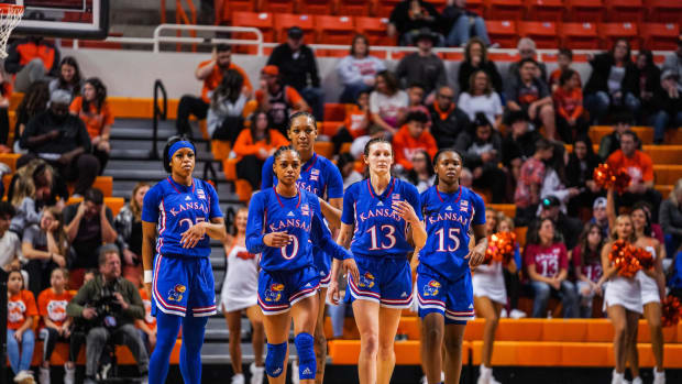Kansas players (from left) Chandler Prater (25), Wyvette Mayberry (0), Taiyanna Jackson (1), Holly Kersgieter (13) and Zakiyah Franklin (15) walk on the court at Gallagher-Iba Arena on December 31, 2022.