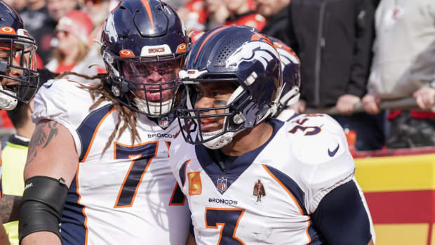 Denver Broncos quarterback Russell Wilson (3) celebrates with guard Quinn Meinerz (77) after scoring against the Kansas City Chiefs during the first half at GEHA Field at Arrowhead Stadium.