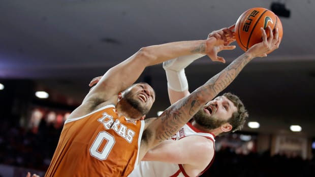 Texas Longhorns forward Timmy Allen (0) and Oklahoma Sooners forward Tanner Groves (35) reach for the ball during an NCAA men's college basketball game between the University of Oklahoma and Texas at Lloyd Noble Center in Norman, Okla., Saturday, Dec. 31, 2022. Texas won 70-69. Oklahoma Vs Texas Basketball