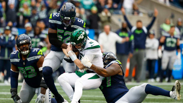 Seattle Seahawks defensive end Darrell Taylor (52) and defensive tackle Quinton Jefferson (77) sack New York Jets quarterback Mike White (5) during the second quarter at Lumen Field.