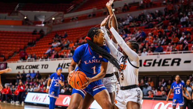 Kansas Jayhawks center Taiyanna Jackson fights through a double-team in a game against the Oklahoma State Cowgirls on December 31, 2022.