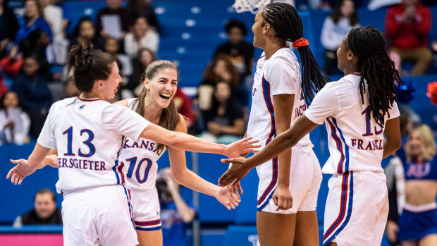 Holly Kersgieter (13), Ioanna Chatzileonti (10), Taiyanna Jackson (1) and Zakiyah Franklin (15) celebrate during a game between the Kansas Jayhawks and Texas Tech Lady Raiders in Allen Fieldhouse.