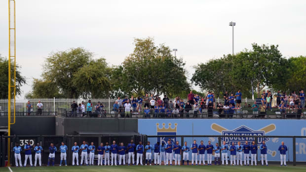 Mar 26, 2022; Surprise, Arizona, USA; Kansas City Royals players look on during the national anthem prior to a spring training game against the Los Angeles Dodgers at Surprise Stadium. Mandatory Credit: Joe Camporeale-USA TODAY Sports