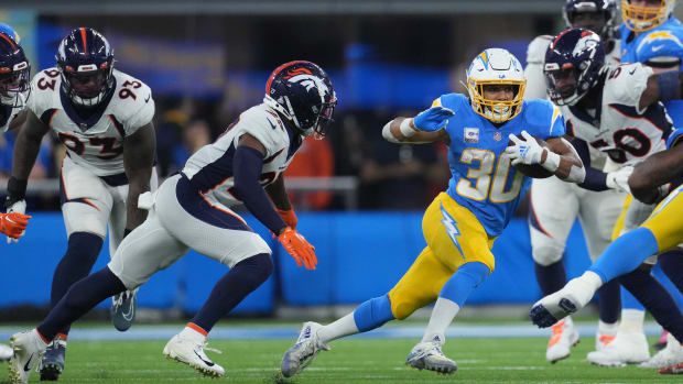 Oct 17, 2022; Inglewood, California, USA; Los Angeles Chargers running back Austin Ekeler (30) is pursued by Denver Broncos cornerback Damarri Mathis (27) and defensive end Dre'Mont Jones (93) at SoFi Stadium. The Chargers defeated the Broncos 19-16 in overtime. Mandatory Credit: Kirby Lee-USA TODAY Sports