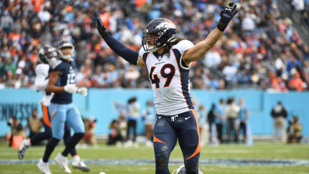 Denver Broncos linebacker Alex Singleton (49) celebrates after a defensive stop against Tennessee Titans tight end Austin Hooper (81) during the first half at Nissan Stadium.