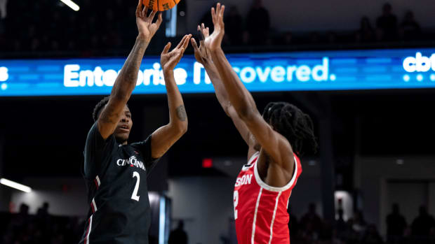 Cincinnati Bearcats guard Landers Nolley II (2) hits a 3-point shot over Houston Cougars guard Tramon Mark (12) in the first half of the NCAA men s basketball game between the Cincinnati Bearcats and the Houston Cougars at Fifth Third Arena in Cincinnati on Sunday, Jan 8, 2023. Ncaa Basketball Houston Cougars At Cincinnati Bearcats