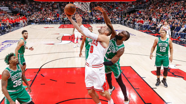 Nov 21, 2022; Chicago, Illinois, USA; Chicago Bulls center Nikola Vucevic (9) goes to the basket against the Boston Celtics guard Jaylen Brown (7) during the second half at United Center.