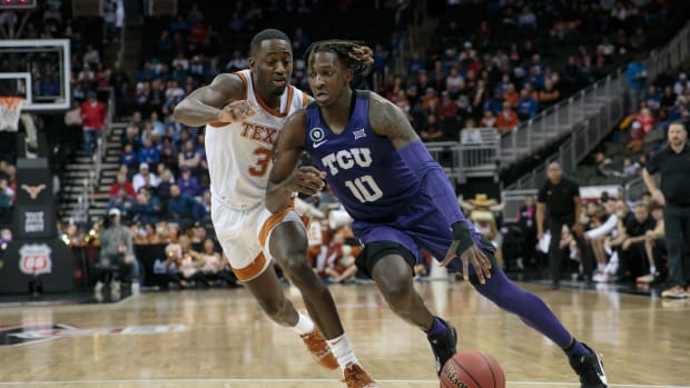 TCU Horned Frogs guard Damion Baugh (10) drives to the basket around Texas Longhorns guard Courtney Ramey (3) during the second half at T-Mobile Center