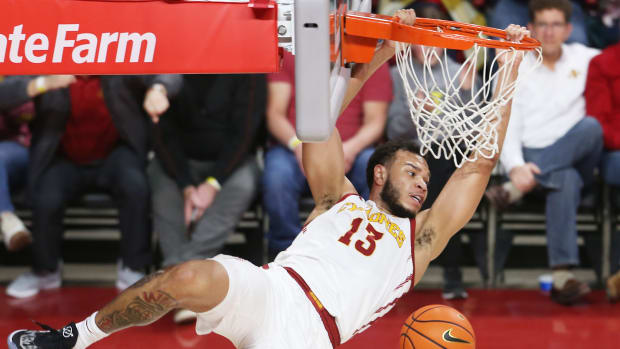 Iowa State University Cyclones guard Jaren Holmes (13) hangs out the rim after a dunk against Texas Tech Red Raiders during the second half at Hilton Coliseum Tuesday, Jan 10, 2023, in Ames, Iowa.