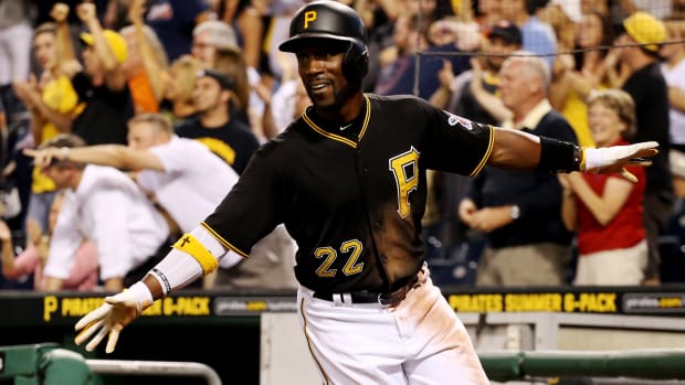 Pirates center fielder Andrew McCutchen (22) reacts after scoring the game-winning run against the Braves during the tenth inning.