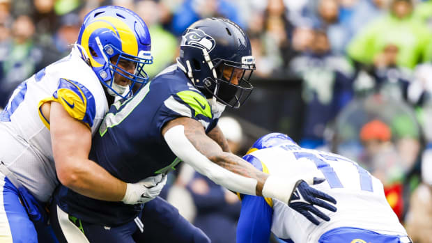 Jan 8, 2023; Seattle, Washington, USA; Seattle Seahawks linebacker Bruce Irvin (51) sacks Los Angeles Rams quarterback Baker Mayfield (17) during the first quarter at Lumen Field. Los Angeles Rams center Coleman Shelton (65) attempts to block Irvin at left.