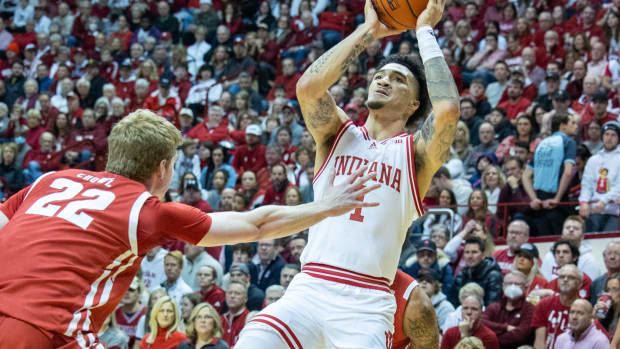 Indiana Hoosiers guard Jalen Hood-Schifino (1) shoots the ball while Wisconsin Badgers forward Steven Crowl (22) defends in the first half at Simon Skjodt Assembly Hall