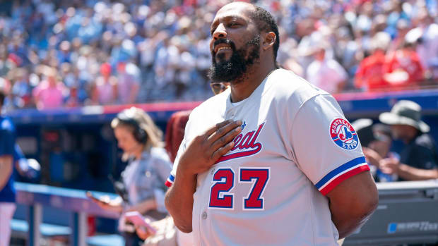 Hall of famer Vladimir Guerrero Sr. with his hand on his heart during the National Anthem at a Blue Jays game.