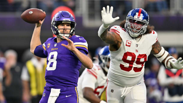 Jan 15, 2023; Minneapolis, Minnesota, USA; Minnesota Vikings quarterback Kirk Cousins (8) passes the ball while defended by New York Giants defensive end Leonard Williams (99) during the first quarter of a wild card game at U.S. Bank Stadium.