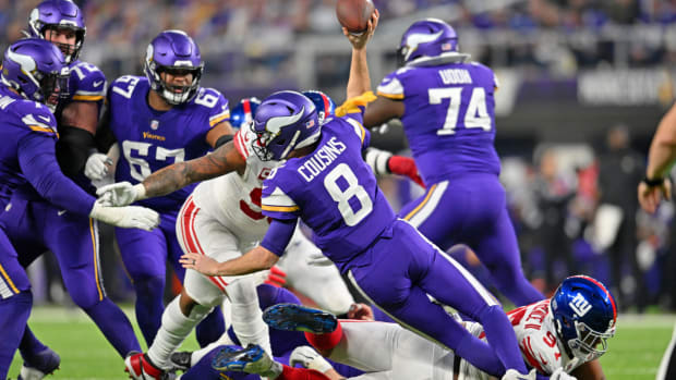 Jan 15, 2023; Minneapolis, Minnesota, USA; Minnesota Vikings quarterback Kirk Cousins (8) passes the ball while being tackled by New York Giants defensive tackle Dexter Lawrence (97) as a penalty flag is thrown during the second quarter of a wild card game at U.S. Bank Stadium. Mandatory Credit: Jeffrey Becker-USA TODAY Sports