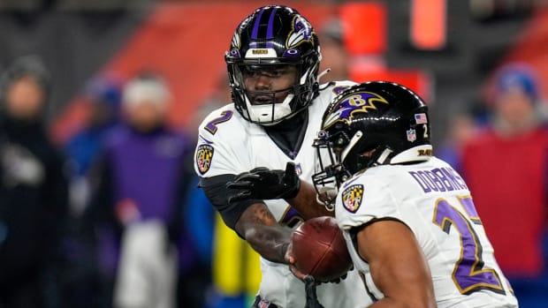 Baltimore Ravens quarterback Tyler Huntley (2) hands off to running back J.K. Dobbins (27) in the first quarter during an NFL wild-card playoff football game between the Baltimore Ravens and the Cincinnati Bengals, Sunday, Jan. 15, 2023, at Paycor Stadium in Cincinnati.The Ravens led 10-9 at halftime. Baltimore Ravens At Cincinnati Bengals Afc Wild Card Jan 15 174