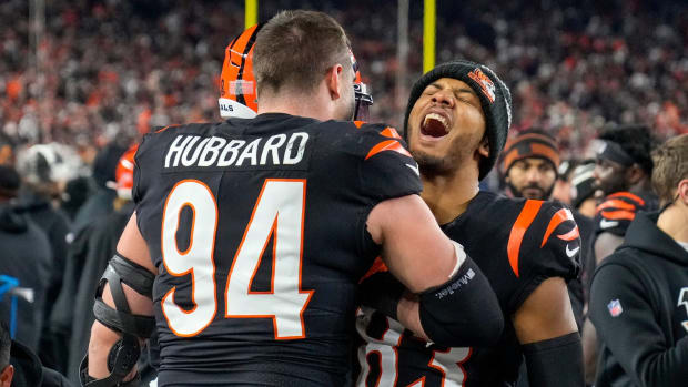 Cincinnati Bengals wide receiver Tyler Boyd (83) celebrates on the bench with Cincinnati Bengals defensive end Sam Hubbard (94) after Hubbard runs back a stripped ball for a 98-yard touchdown in the fourth quarter during an NFL wild-card playoff football game between the Baltimore Ravens and the Cincinnati Bengals, Sunday, Jan. 15, 2023, at Paycor Stadium in Cincinnati. The Bengals advanced to the Divisional round of the playoffs with a 24-17 win over the Ravens. Baltimore Ravens At Cincinnati Bengals Afc Wild Card Jan 15 342