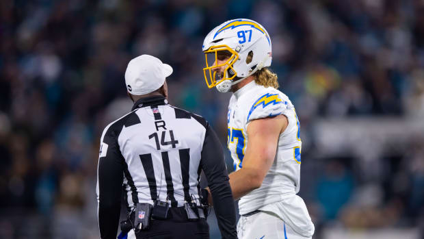 Jan 14, 2023; Jacksonville, Florida, USA; Los Angeles Chargers linebacker Joey Bosa talks with NFL referee Shawn Smith against the Jacksonville Jaguars during a wild card playoff game at TIAA Bank Field. Mandatory Credit: Mark J. Rebilas-USA TODAY Sports