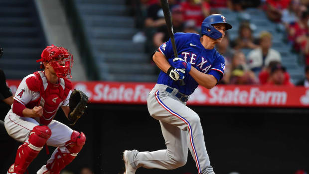 Texas Rangers shortstop Corey Seager hits a single against the Los Angeles Angels